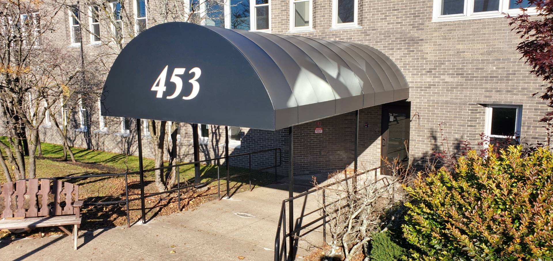 A black Haven vinyl front entry walkway awning.